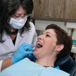 dentist fixing a woman's teeth