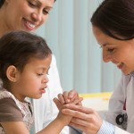 health care worker attending to a young child